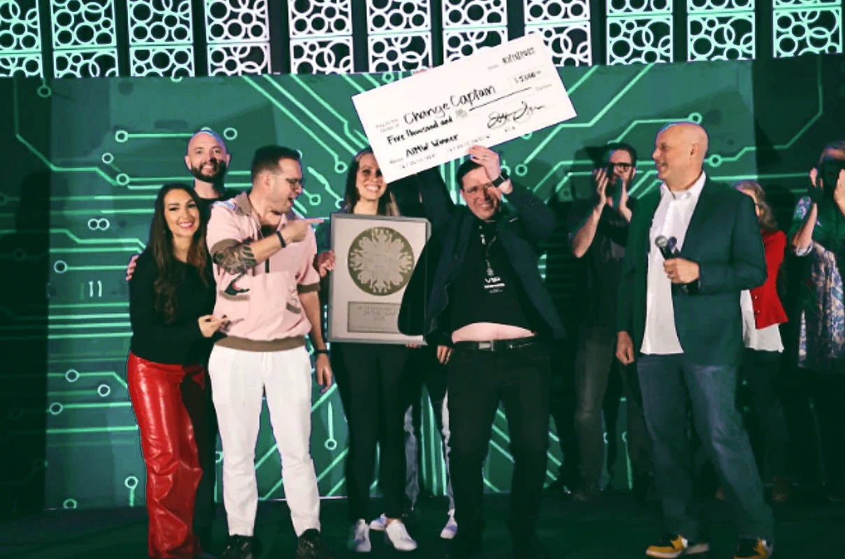 Founders on stage holding an oversized check at a pitch competition